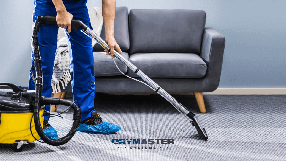 Professional carpet cleaner using single jet DryMaster carpet extractor on commercial carpets.